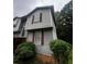This exterior image shows a side view, highlighting the gray siding and red framed windows at 5568 Bradley Cir, Lithonia, GA 30038