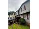 This is a view of the side exterior, and the red brick stairs with a railing leading to the front door at 5568 Bradley Cir, Lithonia, GA 30038