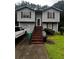 View of the front of a two-story home with a garage and gray siding at 5568 Bradley Cir, Lithonia, GA 30038