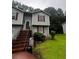 Exterior view of a two-story home with brick stairs and gray siding at 5568 Bradley Cir, Lithonia, GA 30038