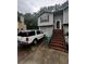 Split level home with a car parked in the driveway at 5568 Bradley Cir, Lithonia, GA 30038