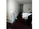 Neglected living room with damaged walls and cluttered items, suggesting need for complete renovation to improve living conditions at 5568 Bradley Cir, Lithonia, GA 30038