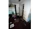 Messy living room area showing items strewn about and peeling walls, requiring a total remodel to be habitable at 5568 Bradley Cir, Lithonia, GA 30038