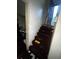 View of the dilapidated carpeted stairway leading to the upper floor at 5568 Bradley Cir, Lithonia, GA 30038