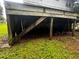 View under elevated home featuring exposed support beams and space for storage at 5568 Bradley Cir, Lithonia, GA 30038