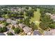 Aerial view of a beautiful community featuring a golf course, lake, and well-maintained homes at 8295 St Marlo Fairway Dr, Duluth, GA 30097