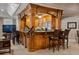 Basement bar area features wood cabinetry and countertops with seating at 8295 St Marlo Fairway Dr, Duluth, GA 30097
