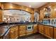 The basement's wet bar has wooden cabinets, granite countertops, and appliances at 8295 St Marlo Fairway Dr, Duluth, GA 30097