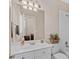The bathroom featuring a vanity, large mirror, and a shower and bath combination at 8295 St Marlo Fairway Dr, Duluth, GA 30097