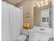Well-maintained bathroom with a shower and tub combo, white fixtures, and ample natural light at 8295 St Marlo Fairway Dr, Duluth, GA 30097