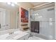 Bright bathroom featuring a glass-enclosed shower with modern fixtures and a sleek white vanity at 8295 St Marlo Fairway Dr, Duluth, GA 30097