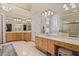 Spacious bathroom with a large vanity, soaking tub, walk-in shower, and elegant lighting fixtures at 8295 St Marlo Fairway Dr, Duluth, GA 30097