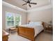Serene bedroom boasts natural light, neutral tones, and a tray ceiling with ceiling fan at 8295 St Marlo Fairway Dr, Duluth, GA 30097