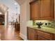 Charming butler's pantry with custom cabinetry, granite countertop and stone tile backsplash at 8295 St Marlo Fairway Dr, Duluth, GA 30097