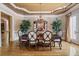Formal dining room featuring hardwood floors, a chandelier, decorative molding, and elegant furnishings at 8295 St Marlo Fairway Dr, Duluth, GA 30097
