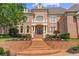 Brick home with manicured landscaping, steps leading to the front door, and a well maintained lawn at 8295 St Marlo Fairway Dr, Duluth, GA 30097