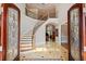 Elegant foyer with a curved staircase, tile flooring, an ornate railing, and natural light at 8295 St Marlo Fairway Dr, Duluth, GA 30097