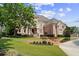 Elegant two-story brick home featuring manicured landscaping and a grand entrance at 8295 St Marlo Fairway Dr, Duluth, GA 30097