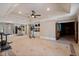 Large gym space with a mirrored wall, gym equipment, and a view of the backyard at 8295 St Marlo Fairway Dr, Duluth, GA 30097