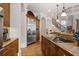 Open kitchen featuring stainless refrigerator, custom counter and hardwood floors at 8295 St Marlo Fairway Dr, Duluth, GA 30097