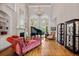 Elegant living room with a piano, fireplace, built-in shelves, high ceiling, and large windows at 8295 St Marlo Fairway Dr, Duluth, GA 30097