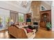 Welcoming living room with vaulted ceilings, stone fireplace, built-in shelving, and lots of natural light at 8295 St Marlo Fairway Dr, Duluth, GA 30097