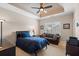The main bedroom featuring a tray ceiling and a sitting area at 8295 St Marlo Fairway Dr, Duluth, GA 30097