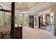 Bright main bedroom with a four-poster bed, French doors to a patio, and a large wardrobe at 8295 St Marlo Fairway Dr, Duluth, GA 30097