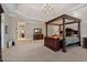 Spacious main bedroom with a tray ceiling, four-poster bed, and ample natural light at 8295 St Marlo Fairway Dr, Duluth, GA 30097