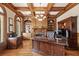 Elegant executive office featuring custom wood ceiling, hardwood floor and built-in shelves at 8295 St Marlo Fairway Dr, Duluth, GA 30097