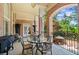 Outdoor patio featuring a brick archway, elegant seating, and a view of the backyard at 8295 St Marlo Fairway Dr, Duluth, GA 30097