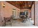 Covered outdoor patio with brick walls, seating, and television at 8295 St Marlo Fairway Dr, Duluth, GA 30097