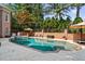 Enjoy the backyard pool with a tanning ledge, spa, and outdoor kitchen and lounge area at 8295 St Marlo Fairway Dr, Duluth, GA 30097