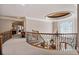 Elegant curved staircase with custom iron railings and an decorative ceiling feature at 8295 St Marlo Fairway Dr, Duluth, GA 30097