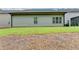 Home's back exterior shows a well-manicured lawn with a glimpse of a screened-in porch for outdoor relaxation at 3112 Patriot Sw Sq, Marietta, GA 30064