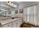 Vanity featuring granite countertop, white cabinets, black hardware, and large mirror at 3112 Patriot Sw Sq, Marietta, GA 30064