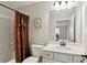 Bathroom features a shower with a patterned curtain and a vanity with white marble countertops at 3112 Patriot Sw Sq, Marietta, GA 30064