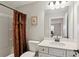 Bathroom features a shower with a patterned curtain and a vanity with white marble countertops at 3112 Patriot Sw Sq, Marietta, GA 30064