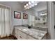 Granite vanity with white cabinets, black hardware, and large mirror at 3112 Patriot Sw Sq, Marietta, GA 30064