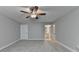 Spacious bedroom with neutral carpet and open doorway to the ensuite bathroom at 3112 Patriot Sw Sq, Marietta, GA 30064