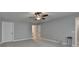 Large bedroom with neutral carpet, ceiling fan, and doorway to another room at 3112 Patriot Sw Sq, Marietta, GA 30064