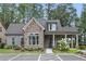Charming home exterior with stone accents, a covered porch, and ample parking at 3112 Patriot Sw Sq, Marietta, GA 30064