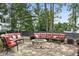 Landscaped backyard with an outdoor seating area surrounding a stone fire pit at 3112 Patriot Sw Sq, Marietta, GA 30064