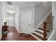 Bright entry hallway featuring hardwood floors, staircase, and neutral paint at 3112 Patriot Sw Sq, Marietta, GA 30064
