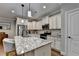 Close up of kitchen island with granite countertop, stainless appliances, and white cabinetry at 3112 Patriot Sw Sq, Marietta, GA 30064