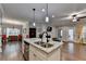 Kitchen island with a sink. Stainless steel appliances and a view of the living area at 3112 Patriot Sw Sq, Marietta, GA 30064