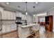 Modern kitchen with white cabinets, granite countertops, stainless steel appliances, and a breakfast bar at 3112 Patriot Sw Sq, Marietta, GA 30064