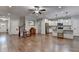 Open-concept living room featuring hardwood floors, a ceiling fan, and a view into the kitchen at 3112 Patriot Sw Sq, Marietta, GA 30064