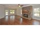 Spacious living area with stone fireplace, hardwood floors, and plenty of natural light at 3112 Patriot Sw Sq, Marietta, GA 30064