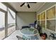 The screened porch with ceiling fan has an outdoor table setting, ideal for enjoying the outdoors with comfort at 3112 Patriot Sw Sq, Marietta, GA 30064